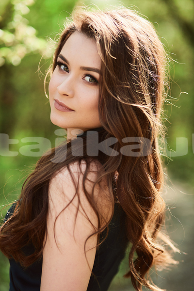 Big with watermark beautiful girl stands park