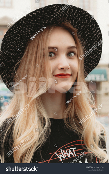 Big with watermark stock photo portrait of cute russian girl outdoors 1452645176
