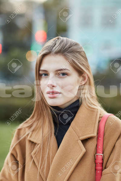 Big with watermark 109337201 young beautiful girl standing in the center of moscow portrait of russian girl close up autumn